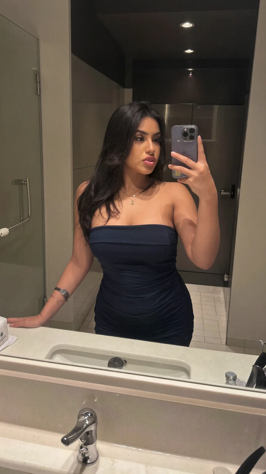 Latina woman mirror selfie in navy strapless dress